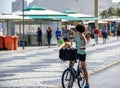 Boy standing with bicycle and with dog in basket on the bike path of Copacabana beach Royalty Free Stock Photo