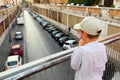 Boy standing on bridge, holding hands on railing Royalty Free Stock Photo