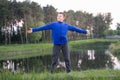 The boy is standing with his arms wide apart Royalty Free Stock Photo