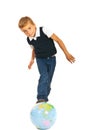 Boy standing with legs on world globe Royalty Free Stock Photo