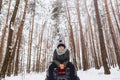 A boy is standing near a quad bike in the middle of the forest Royalty Free Stock Photo