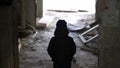 Boy is standing in an old ruined house, demolition old ramshackle building