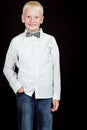 Boy standing with one hand in pocket smiles Royalty Free Stock Photo