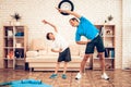 Smiling Father and Son Doing Tilts Side at Home. Royalty Free Stock Photo