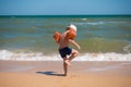 Boy standing on sea coast at surf and looking to water Royalty Free Stock Photo