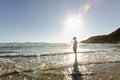 A boy standing in the shallows at the beach Royalty Free Stock Photo