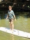 Boy standing on surf Royalty Free Stock Photo