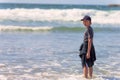 Boy standing in surf on Oregon Coast Royalty Free Stock Photo