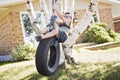 Boy standing on tire swing Royalty Free Stock Photo