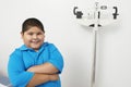 Boy Standing By Weighing Scale In Clinic Royalty Free Stock Photo