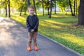 Boy stands in the alley in the park.