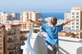 A boy stands on the balcony of the hotel Royalty Free Stock Photo