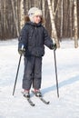 Boy stands on cross-country skis, winter Royalty Free Stock Photo