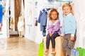 Boy stands and girl sits with shopping bags Royalty Free Stock Photo