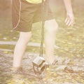 A boy stands in the river on outdoor and destroys a mirrorless camera