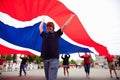 Boy stands underneath British Flag