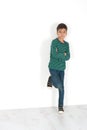 The boy stands at a wall and thinks of meaning. Royalty Free Stock Photo