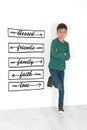 The boy stands at a wall and thinks of meaning of life. Royalty Free Stock Photo