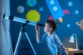 Boy stargazing at night with telescope Royalty Free Stock Photo