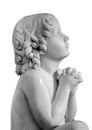 Boy statue pray to God with hands held together. Beautiful old stone statue of praying child isolated on white Royalty Free Stock Photo