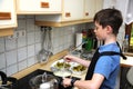 Boy stirring sauce Royalty Free Stock Photo