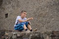 The boy on the stone fence Royalty Free Stock Photo