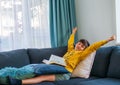 A boy stress up body relaxing from reading the book on the couch in free time
