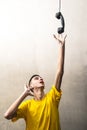 Boy stretching an arm to pick up an old phone handset Royalty Free Stock Photo