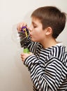 Boy in striped vest and a big soap bubble