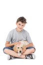 Boy stroking dog while sitting over white background Royalty Free Stock Photo