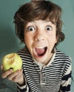 Boy with strong white teeth bite apple