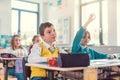 Boy student in class knowing an answer raising his hand Royalty Free Stock Photo