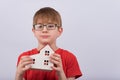 Boy student holding a model house. Homeschooling concept Royalty Free Stock Photo