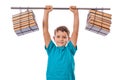 Education concept. Boy student lifting an impromptu barbell from the tube and books, demonstrating that knowledge is power.