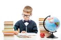 Boy student at the table alone doing homework on a white