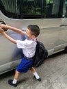 Boy, student, wearing mask Opening the door of the school bus to travel to school to study Prevention of Covit-19