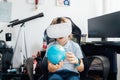 Boy studies space with help of technology and app. Kid in Virtual reality headset learning Solar system planets at home