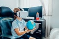 Boy studies space with help of technology and app. Kid in Virtual reality headset learning Solar system planets at home