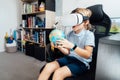 Boy studies space with help of technology and app. Kid in Virtual reality headset learning Solar system planets at home