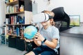 Boy studies space with help of technology and app. Kid in Virtual reality headset learning Solar system planets at home