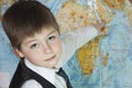 The boy is studying the map of the world Royalty Free Stock Photo