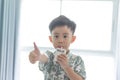 The boy is sucking milk from the milk box. He likes milk box so much Royalty Free Stock Photo