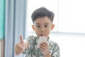 The boy is sucking milk from the milk box. He likes milk box so much Royalty Free Stock Photo