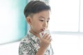 The boy is sucking milk from the milk box. He likes milk box so much Royalty Free Stock Photo