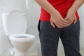 Boy suffering from hemorrhoid in rest room, closeup