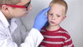 An allergist or dermatologist examines red spots on a childÃ¢â¬â¢s face. The boy suffers from a rash, hives and itching. Food Allergy