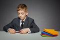 Boy in suit making color paper planes