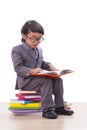 Boy in suit reading a book