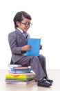 Boy in suit reading a book