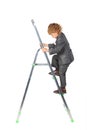 Boy in suit rises on step-ladder